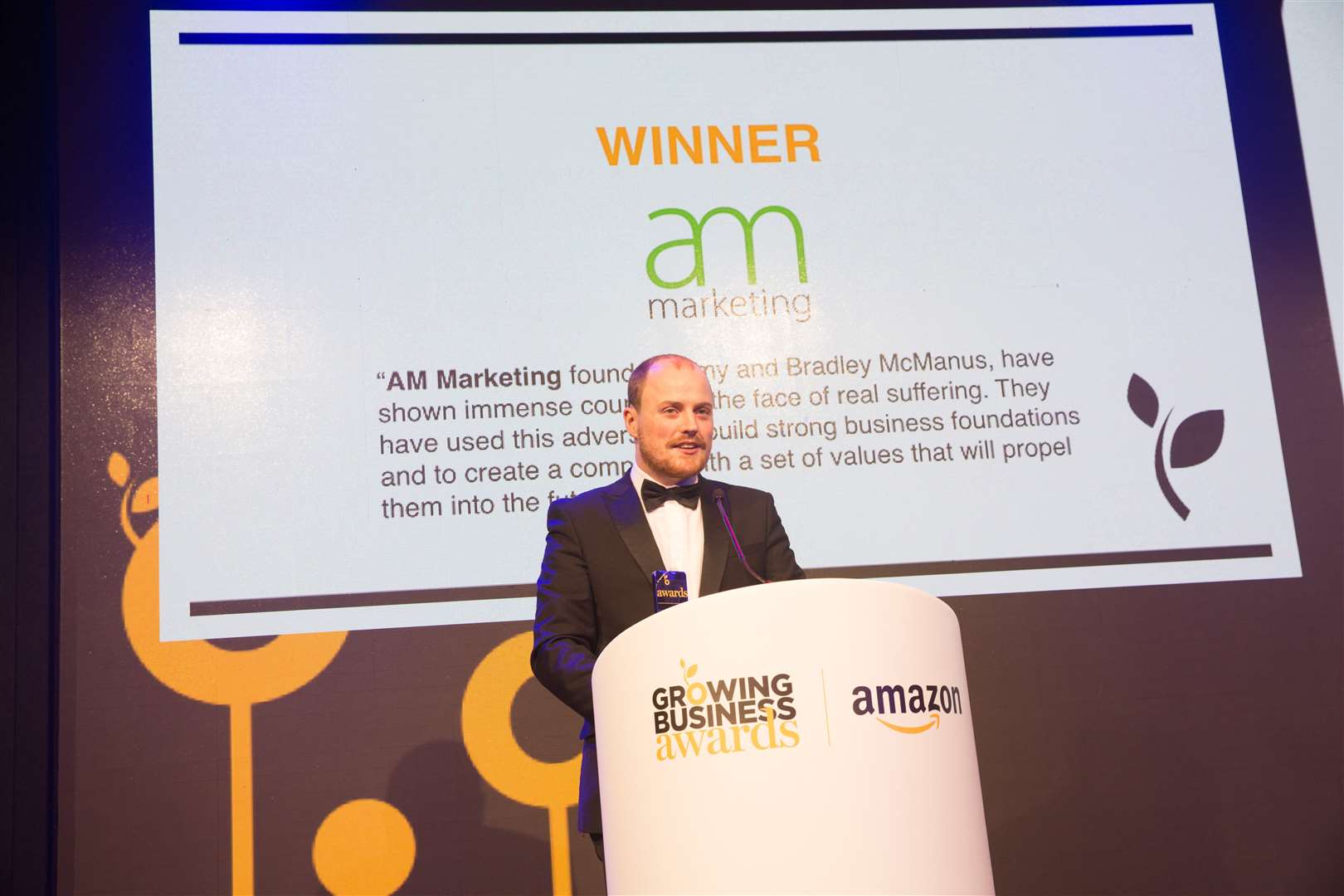 Bradley McManus of AM Marketing collects the Jeff Paterson Triumph Over Adversity award at the Amazon Growing Business Awards