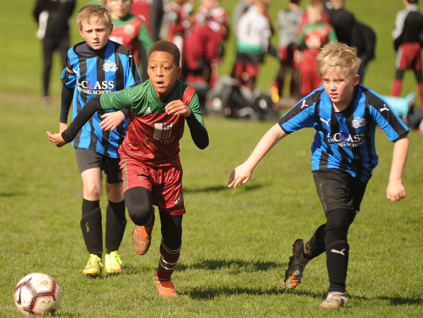 Omega 92 under-12s (blue) give chase with Cobham Colts Blue under-12s Picture: Steve Crispe FM7825586