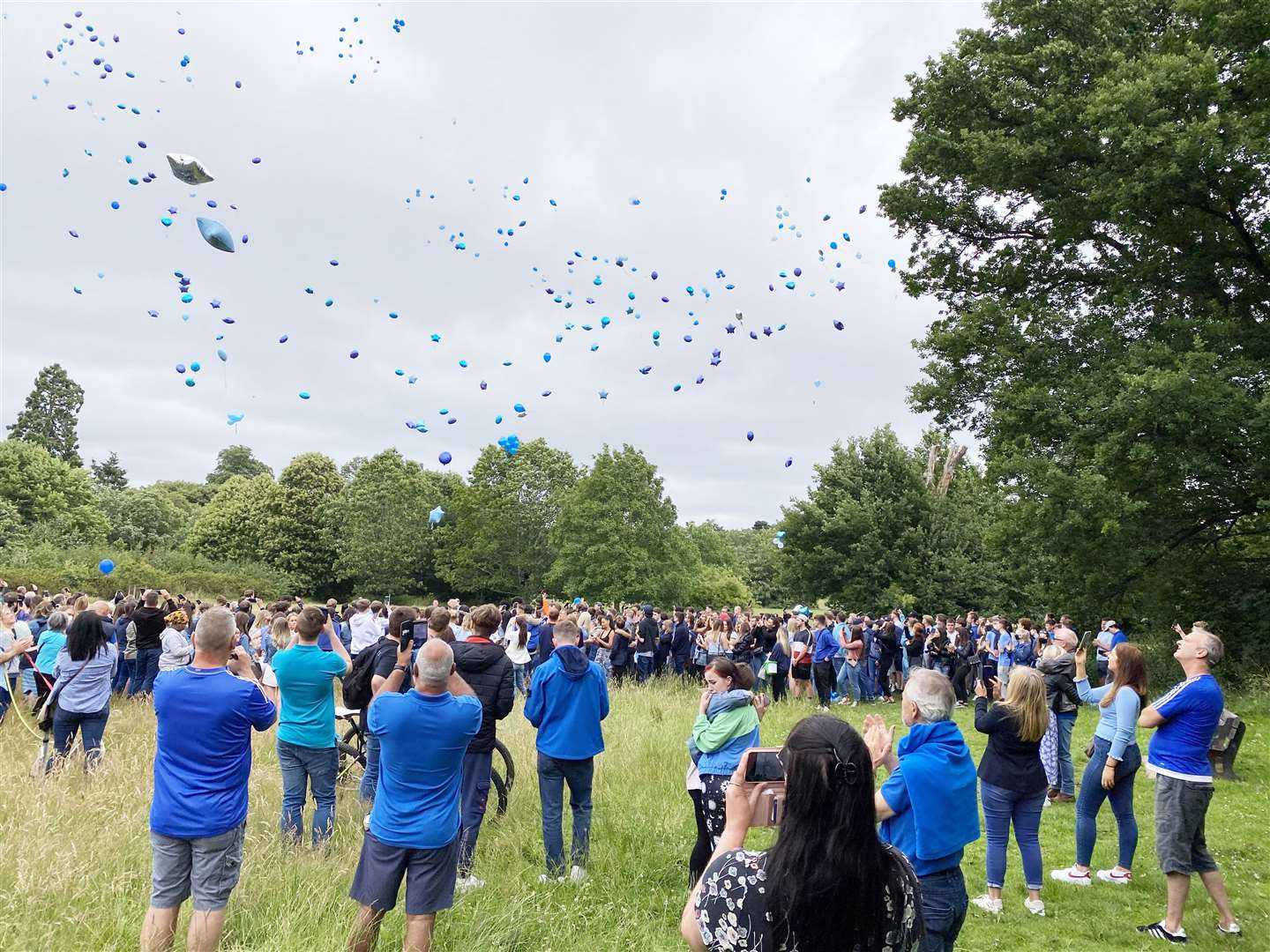 Dressed in blue, friends and family of Elliott Holmes release balloons at Camer Park in Meopham Picture: Barry Goodwin