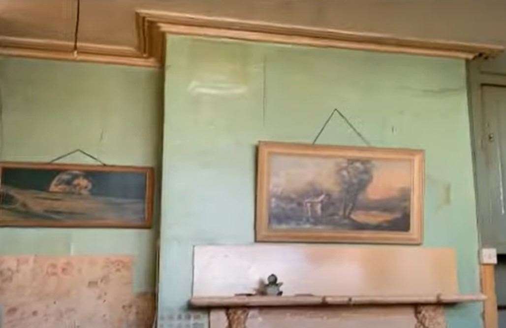 Some paintings on the wall.  Image: Clive Emson / YouTube