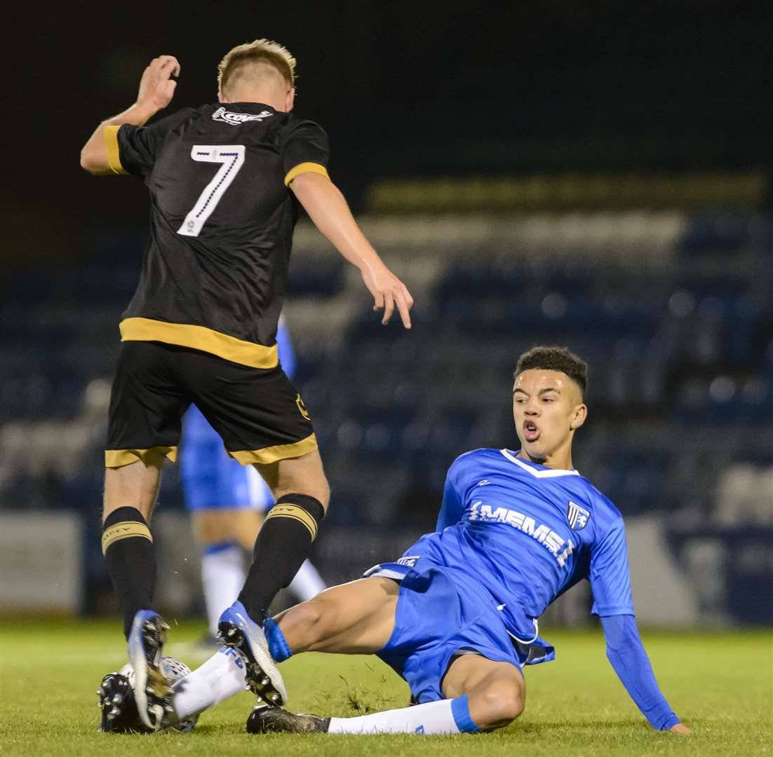 TJ Bramble slides in for Gillingham against Portsmouth. Picture: Andy Payton