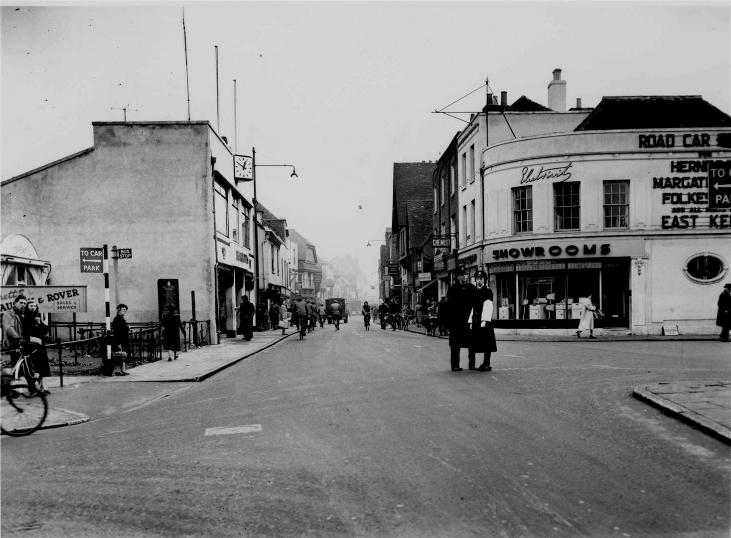 Looking up St Peter's Street from the Westgate, Canterbury, in November 1953. The Electricity showrooms on the corner - demolished in 1961 for road widening that never came - used to be the Corner House Cafe. Just visible (right) are the destinations of the East Kent Road Car Company, whose bus station was in St Peter's Place until the mid-1950s