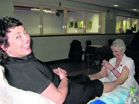 Tina Eldridge enjoys a foot massage from reflexologist Christine McCarthy