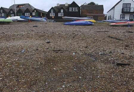 The crater left in the shingle by the exploded gas canister. Picture: CHRIS DAVEY