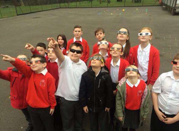 Pupils from Langafel C of E School looks to the skies during the solar eclipse