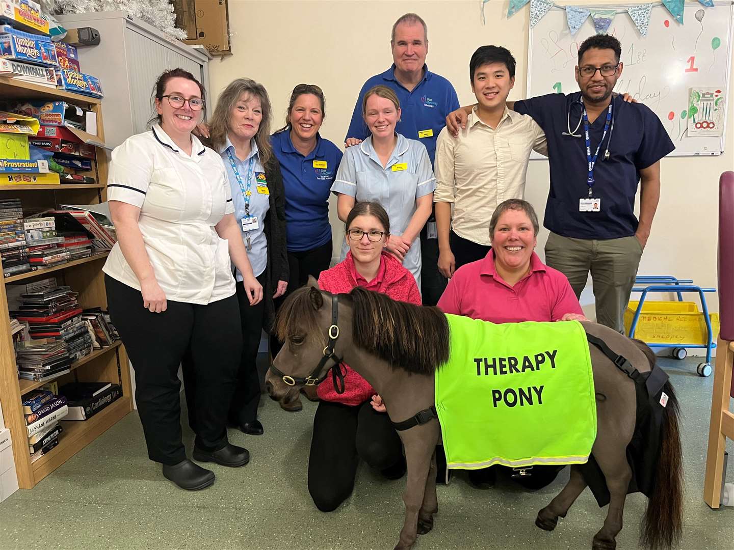 Therapy pony George with his owner Michelle (bottom right) and staff and volunteers from the Sheppey frailty unit
