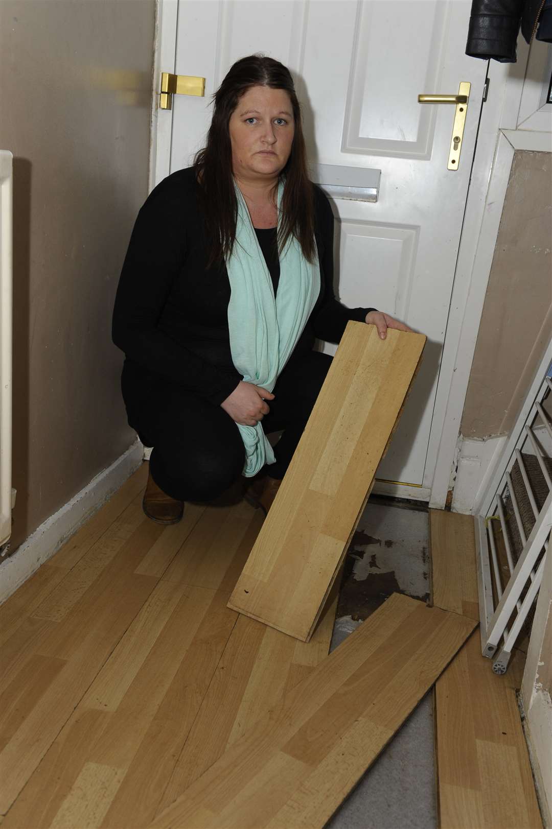 Emma Kershaw with her damaged floor boards.