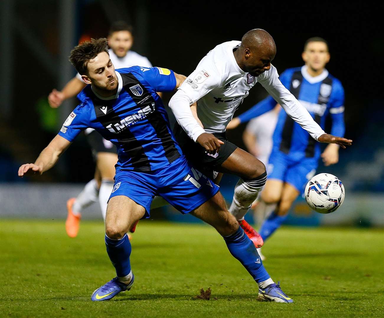 Gillingham's Robbie McKenzie and the Tractor Boys' Sone Aluko in a tangle. Picture: Andy Jones
