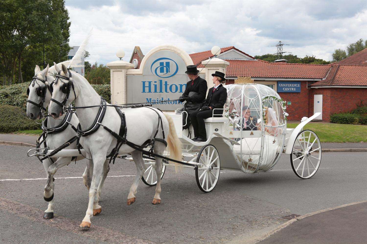 The glass carriage, led by two white horses