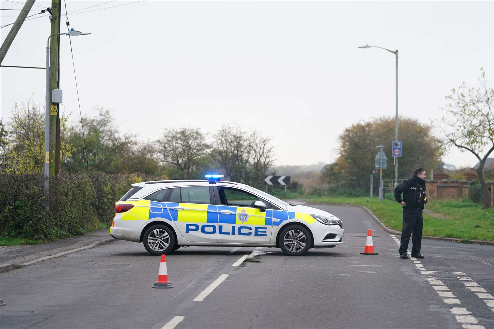 A police car blocks access to the scene in Meadow Lane (Mike Egerton/PA)