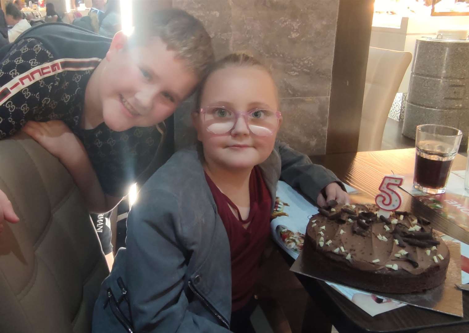 Ruby celebrating five years of being in remission with her brother, Freddy