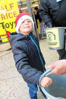 Oliver Stephenson, aged 4, from Sheerness, makes a donation