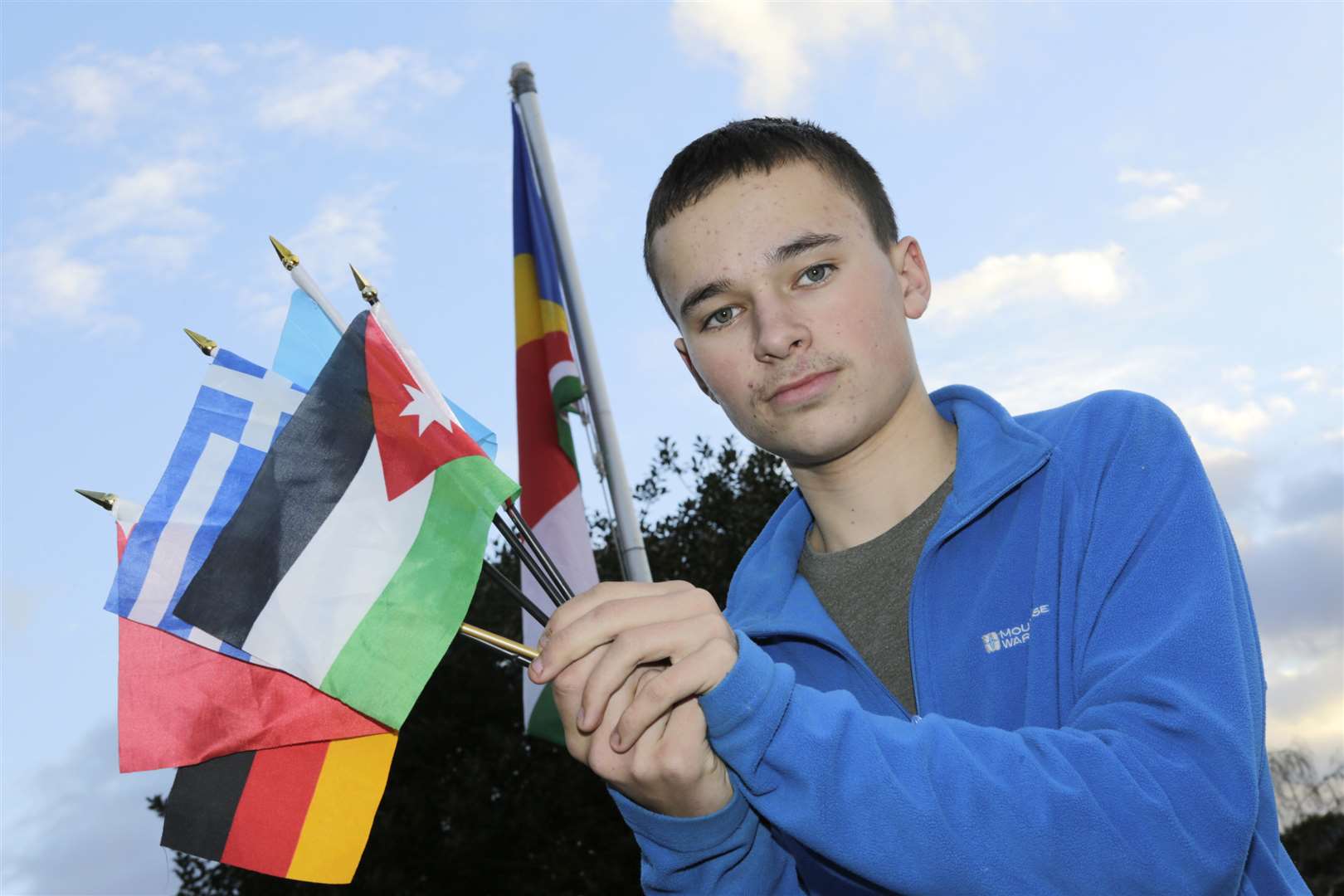 Liam, 14, with some of his vast collection of flags