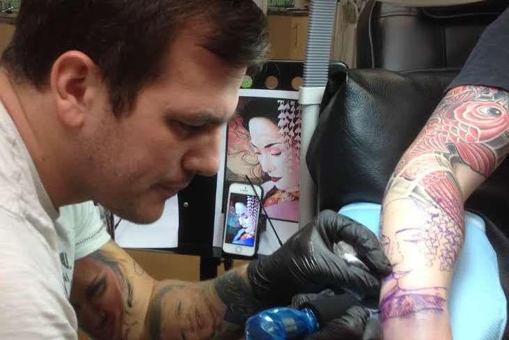 Tattoo artist Alex Crook in action