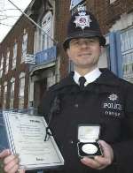 PC Ian Woodland with his medal and certificate