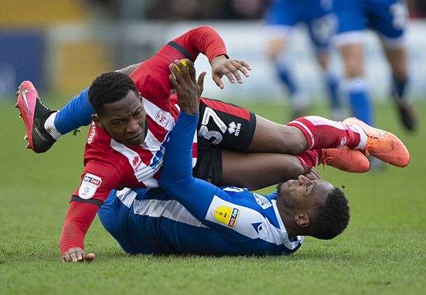 Lincoln's Tayo Edun was booked for this foul on Brandon Hanlan. He got a second yellow late on when the two players clashed. Picture: Ady Kerry