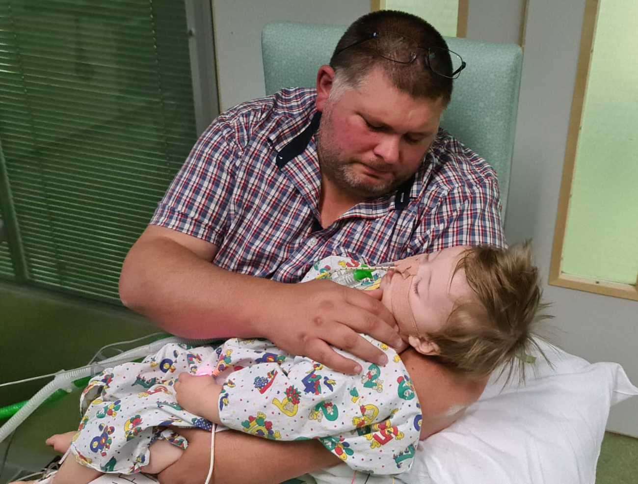 Oliver Steeper pictured with his father Lewis in hospital after choking on food at Jelly Beans Day Nursery in Ashford. Picture: Steeper family