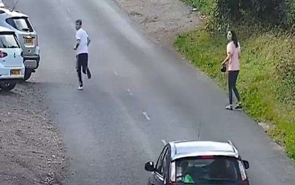 A second male, left, is then seen running from where the Renault crashed (West Midlands Police/PA)