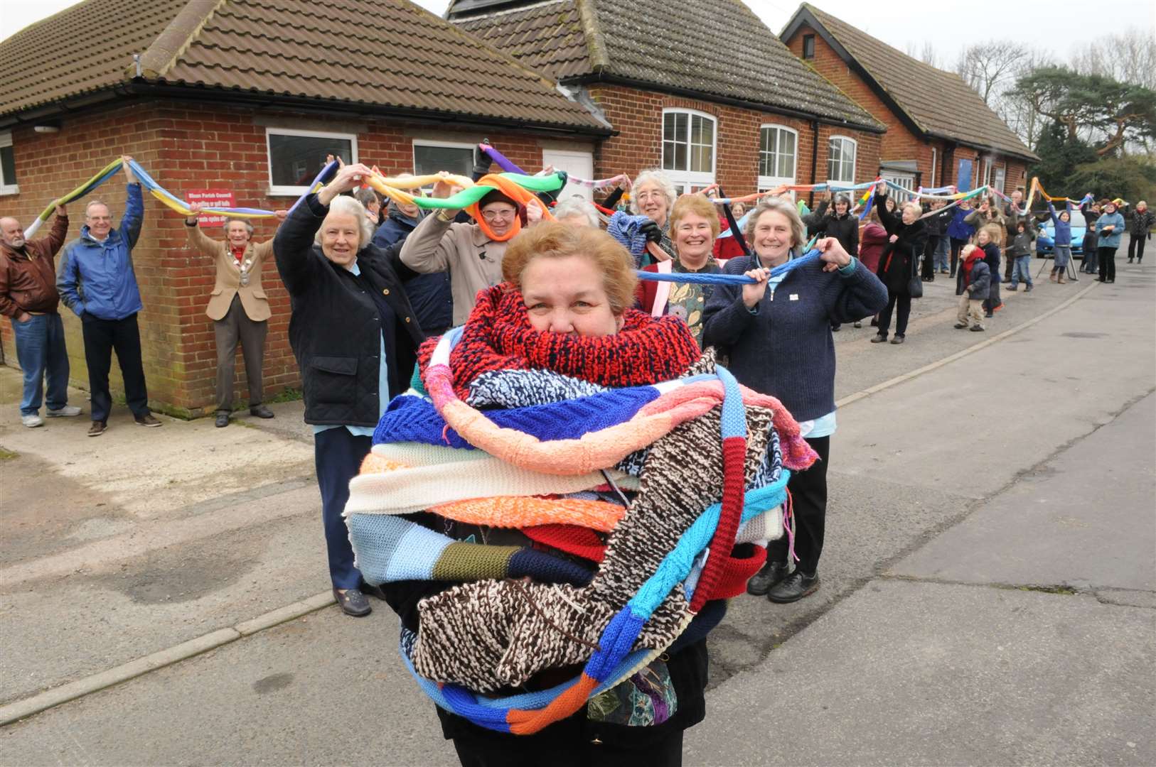 Cllr Barbara Flack wrapped in a giant scarf created by knitters in Blean as part of a world record attempt in 2012