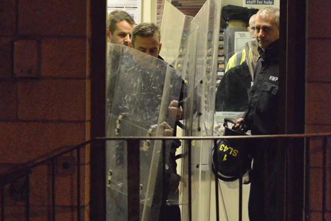 Last November's riot at HMP Maidstone. Officers in riot gear are seen leaving the building