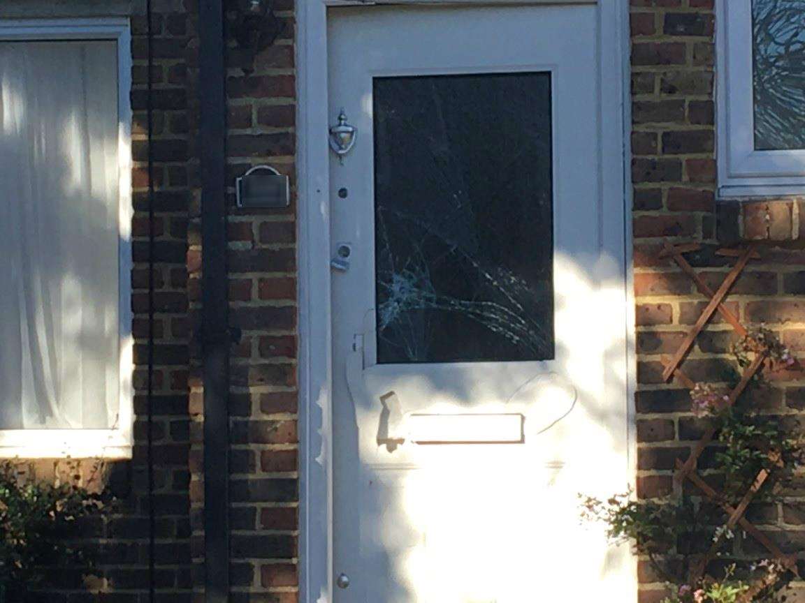 The front door of the house has been smashed by police