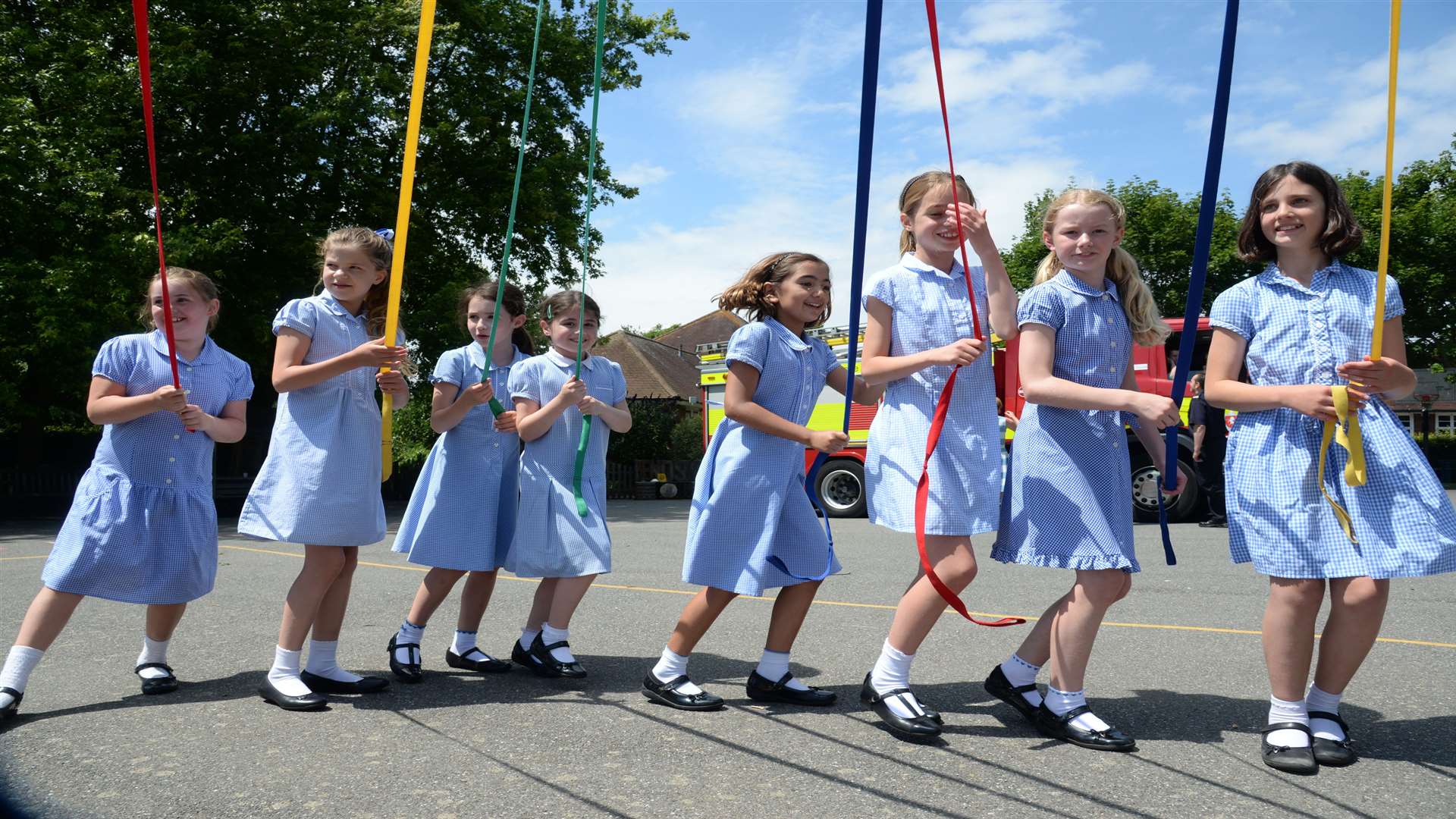 Pupils dancing around the Maypole at the Sheldwich Primary School summer music festival