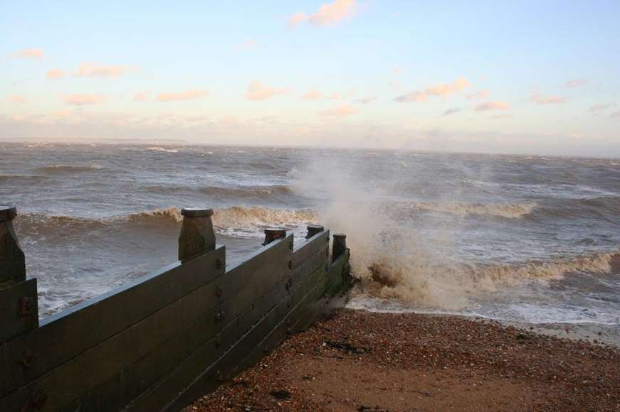 Waves crash against the beach in stormy Whitstable. Library picture