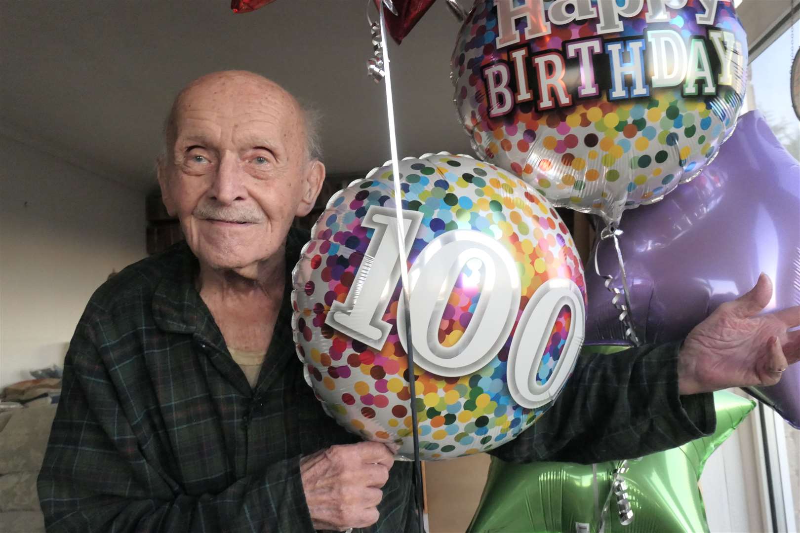 Former Halifax bomber co-pilot George Smith celebrates his 100th birthday at his bungalow in Minster, Sheppey. Picture: Barry Hollis