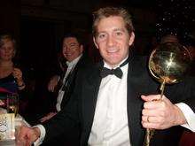 Matthew Pack, CEO for Holiday Extras, holds the Globe Award