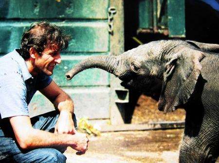 Former keeper Dave Magner with a baby elephant