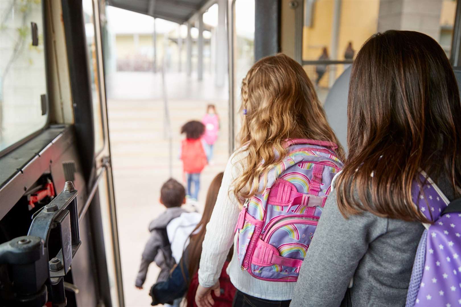 Children leaving a school bus. Stock image