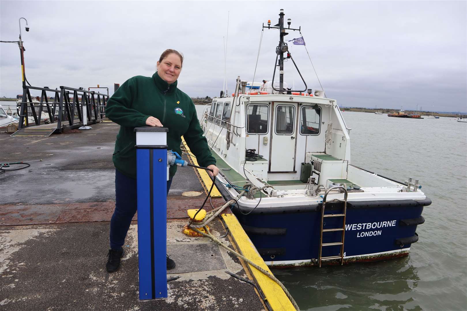 Rachel Collier with one of the six new electricity hook-ups for visiting boats at Queenborough Harbour