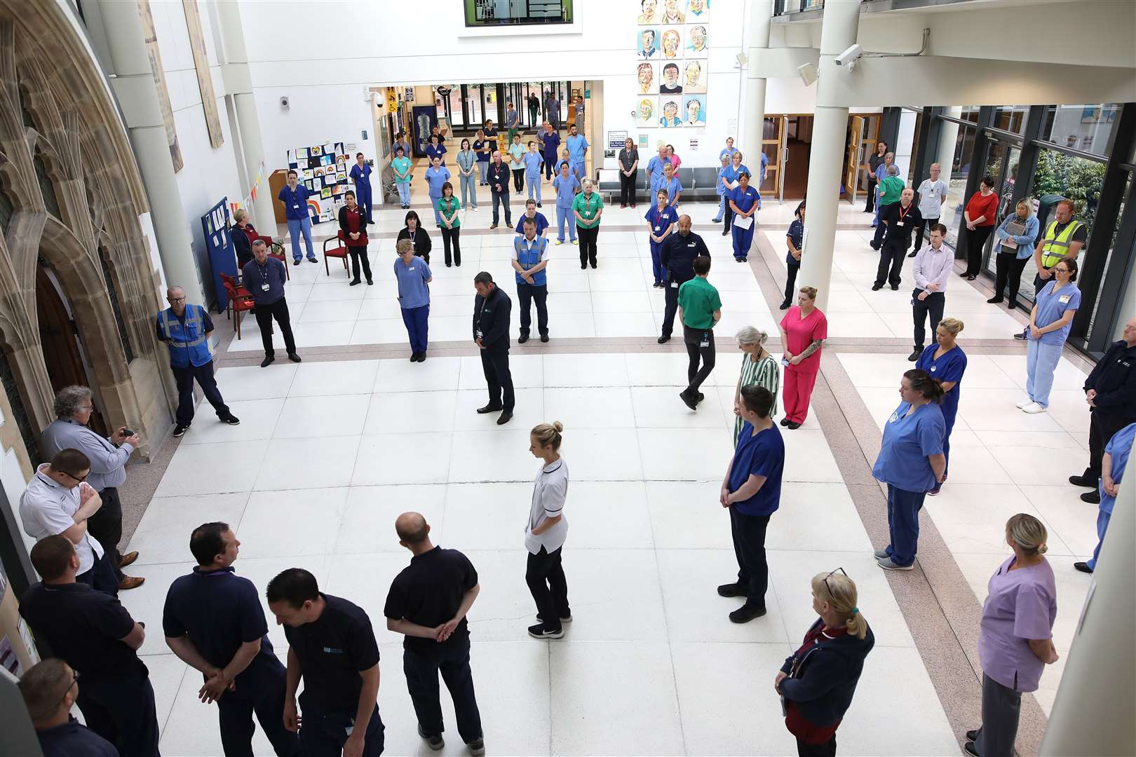 NHS staff at the Mater hospital in Belfast, during a minute’s silence to pay tribute to the NHS staff and key workers who have died during the coronavirus outbreak (Peter Morrison/PA)
