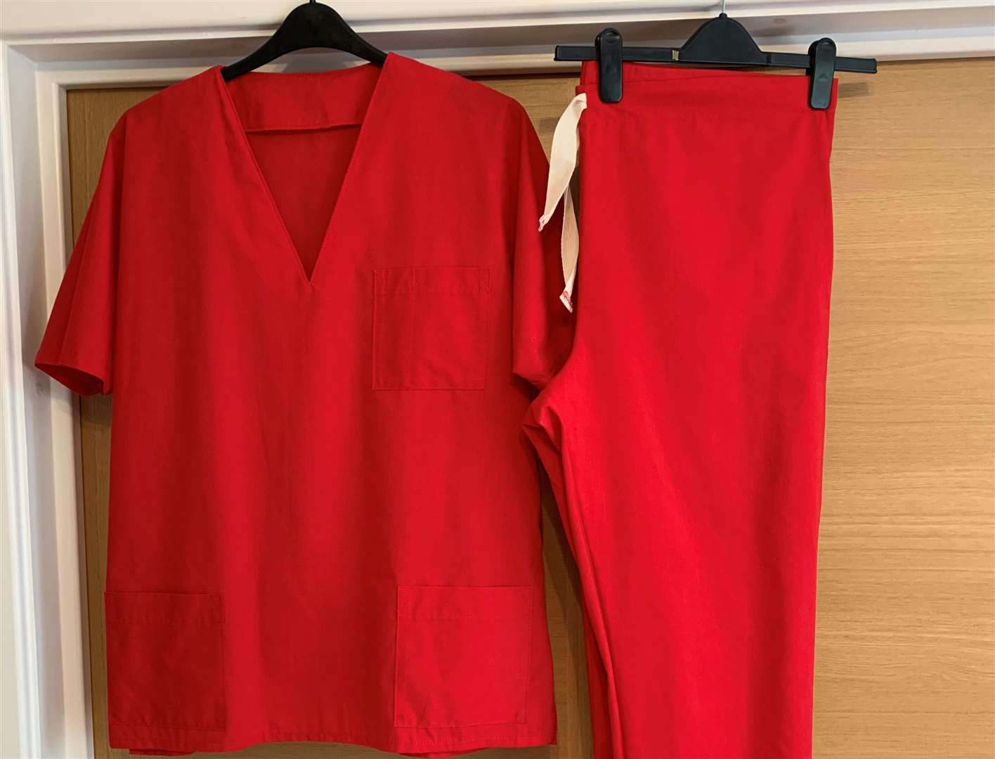A red scrub set made for a key worker