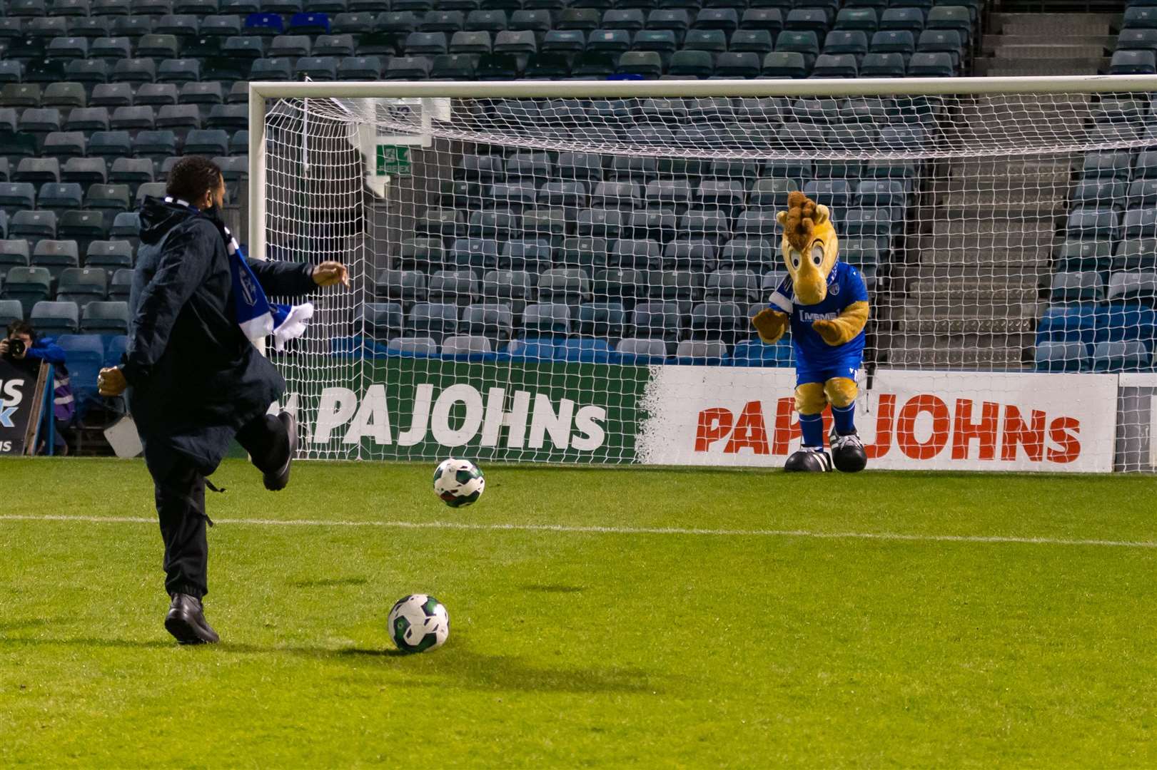 Anthony takes a penalty against Gills mascot. Picture: Kent Pro Images
