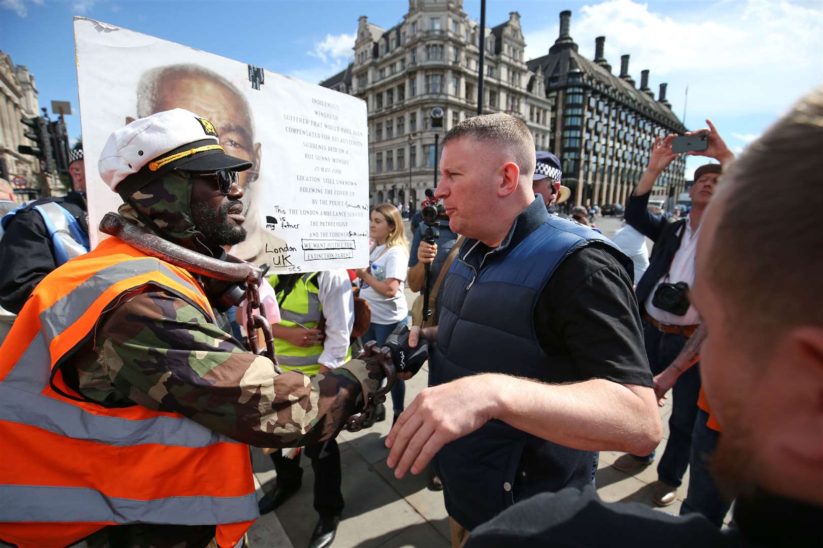 Britain First leader Paul Golding (right) shakes hands with a protester in Parliament Square (Jonathan Brady/PA)