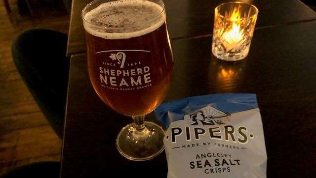 Illuminated by my personal tea light is a pint of Whitstable Bay Pale Ale and a packet of ‘not cheap’ Pipers crisps