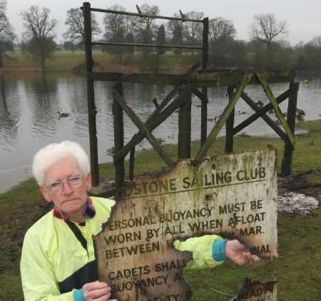 David Fillery with the charred remains of the club's sign. Picture: JOHN WESTHROP