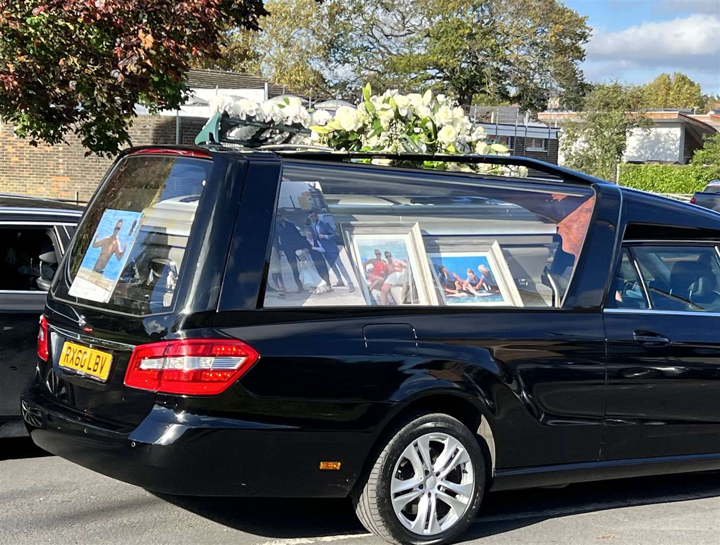 Flowers were left on top of one of the hearses. Picture: Barry Goodwin