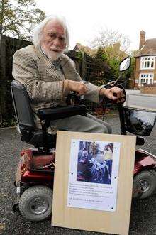 Tony Hickson with a poster showing his Great Dane, Daisy