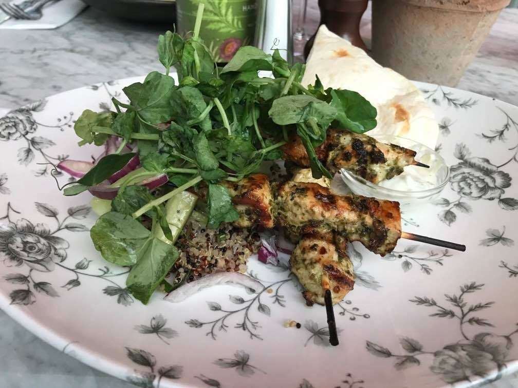 Mojo marinated chicken skewers with grains, wild rice, cucumber and red onion salad, tzatziki and grilled flatbread