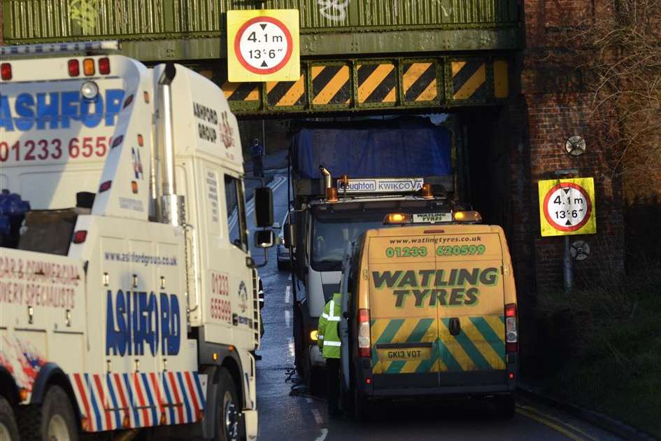 Recovery workers arrive to remove the wedged lorry. Picture: Gary Browne