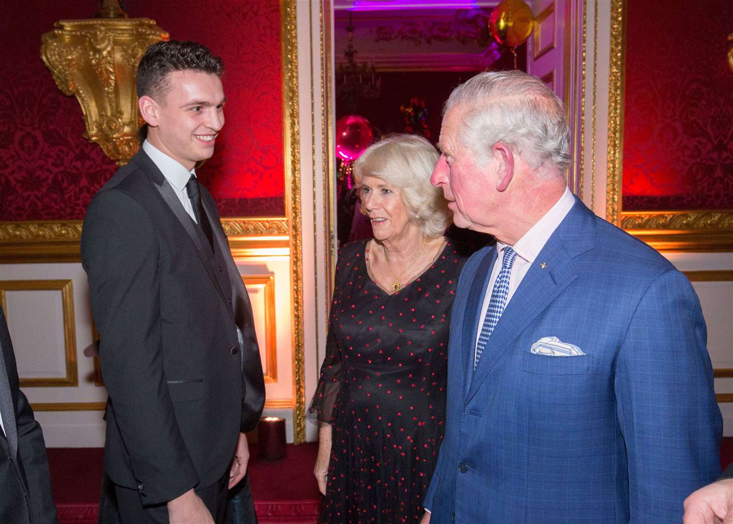 Joshua King meets Prince Charles and Camilla at the royal's Christmas party. Picture: Ian Jones