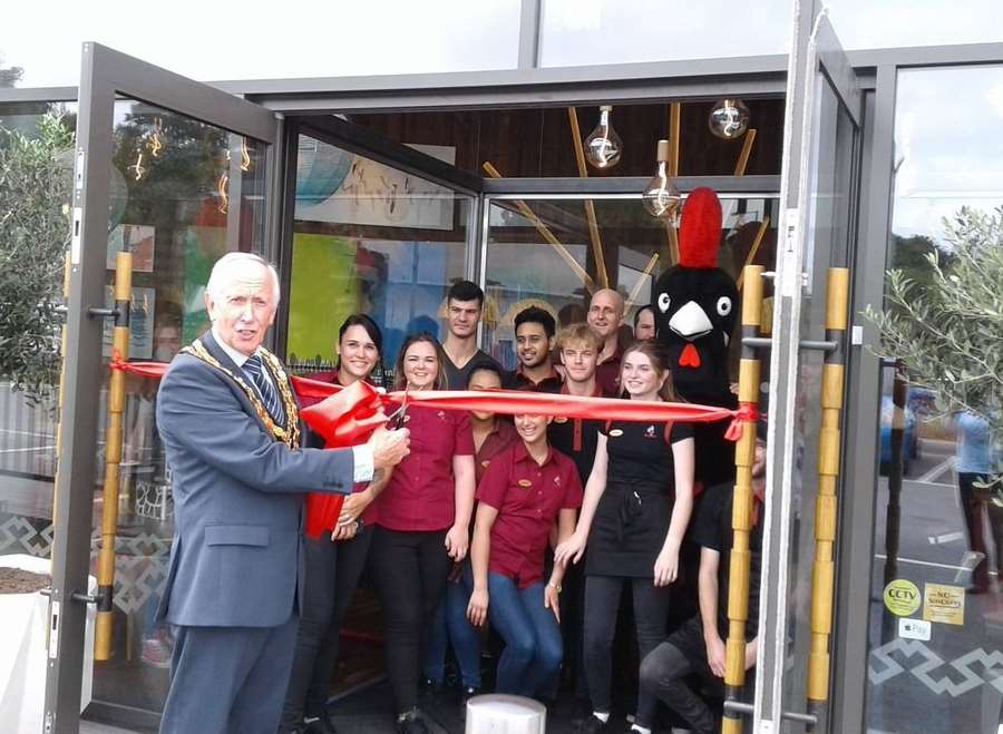Cllr Roger Dalton, mayor of Tonbridge and Malling, cuts the ribbon of the new Nando's.