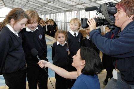ITV Meridian's Rachel Hepworth interviews pupils after the announcement of the result of the People's Millions vote in favour of Joy Lane School swimming pool
