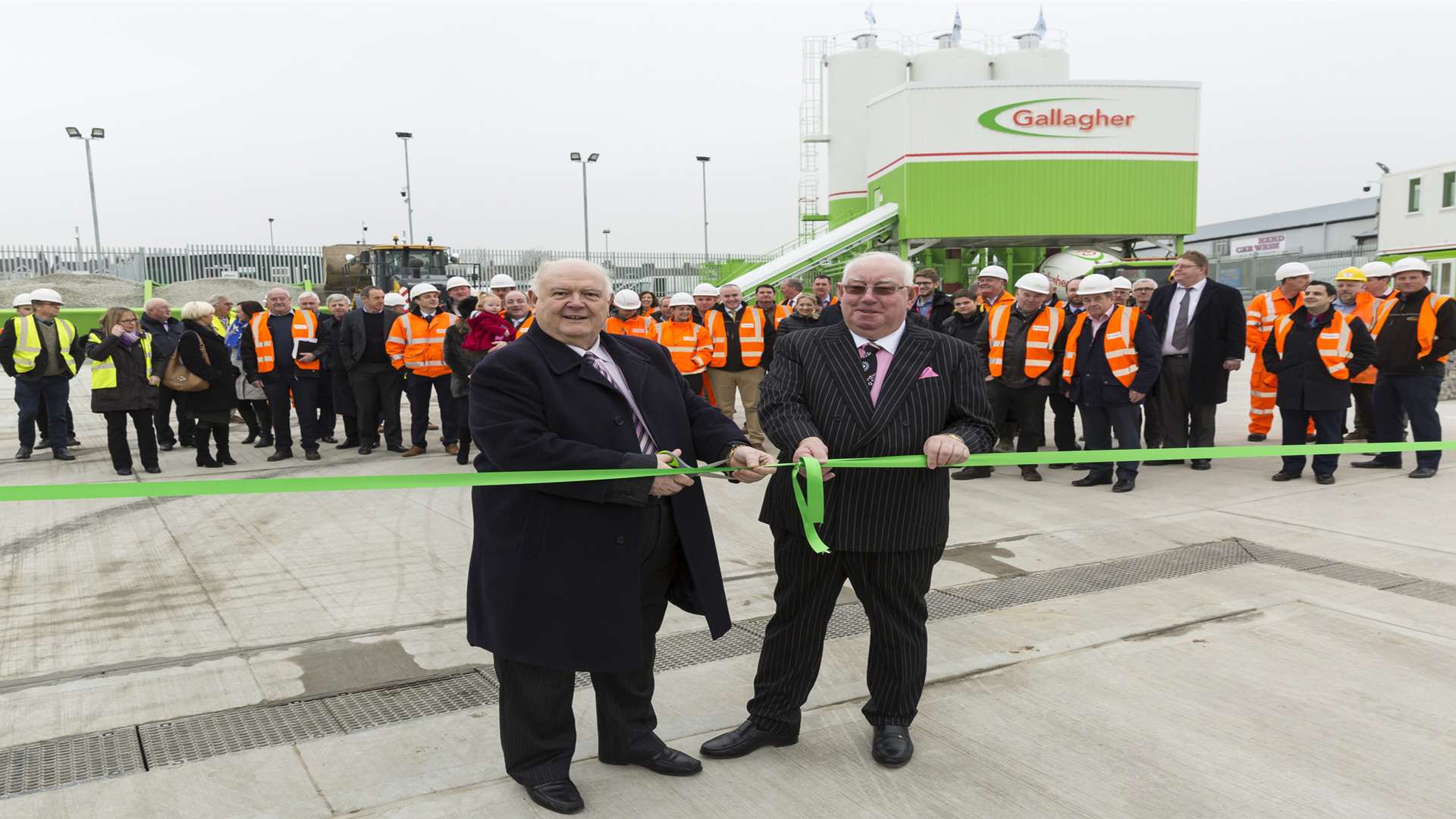 Ashford Borough Council leader Gerry Clarkson, left, cuts the ribbon on a new concrete and aggregate depot in Ashford with Pat Gallagher from Gallagher Group