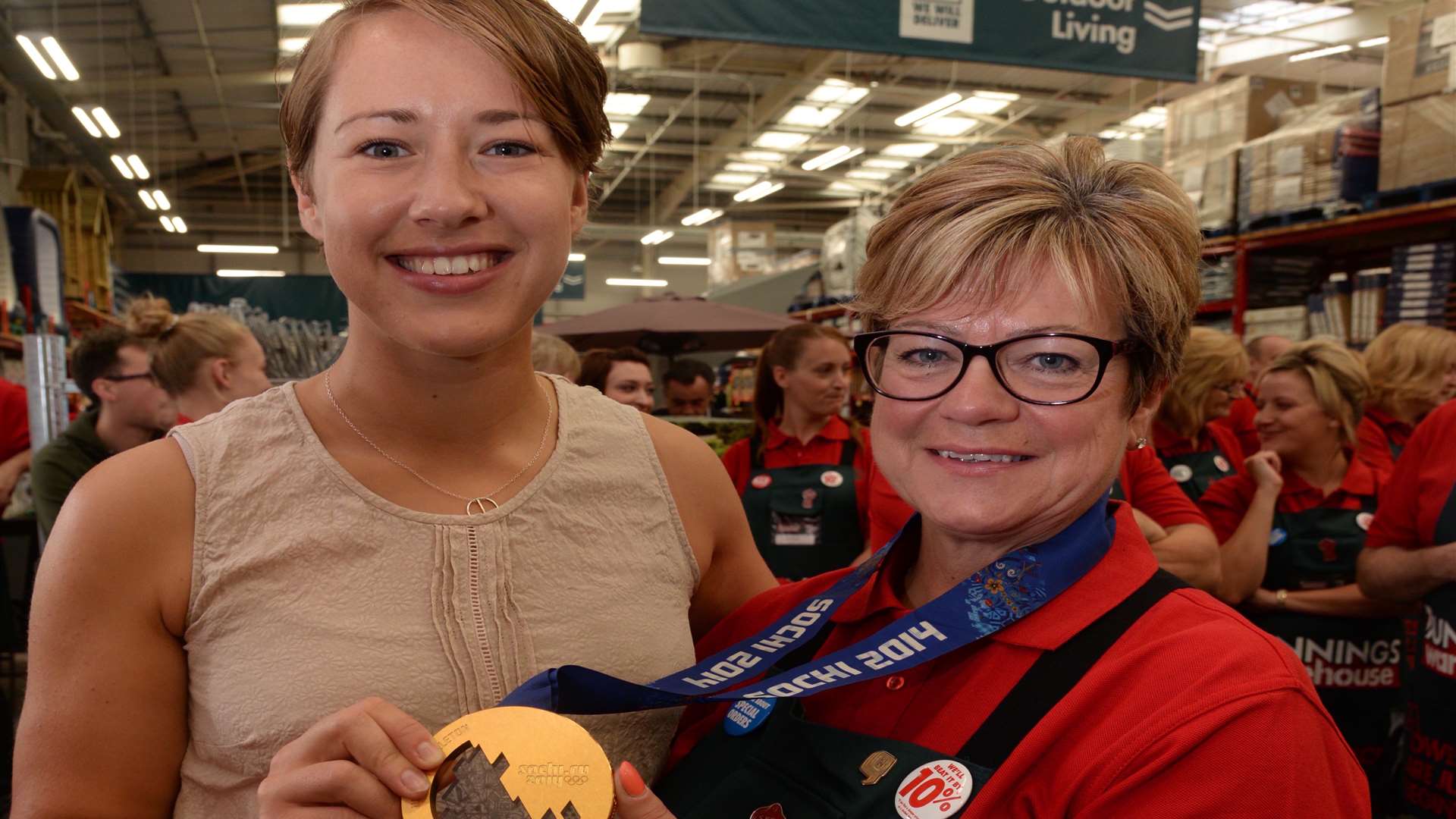 Lizzy Yarnold shows Mandy Blackman her gold medal at the opening of the Bunnings Warehouse