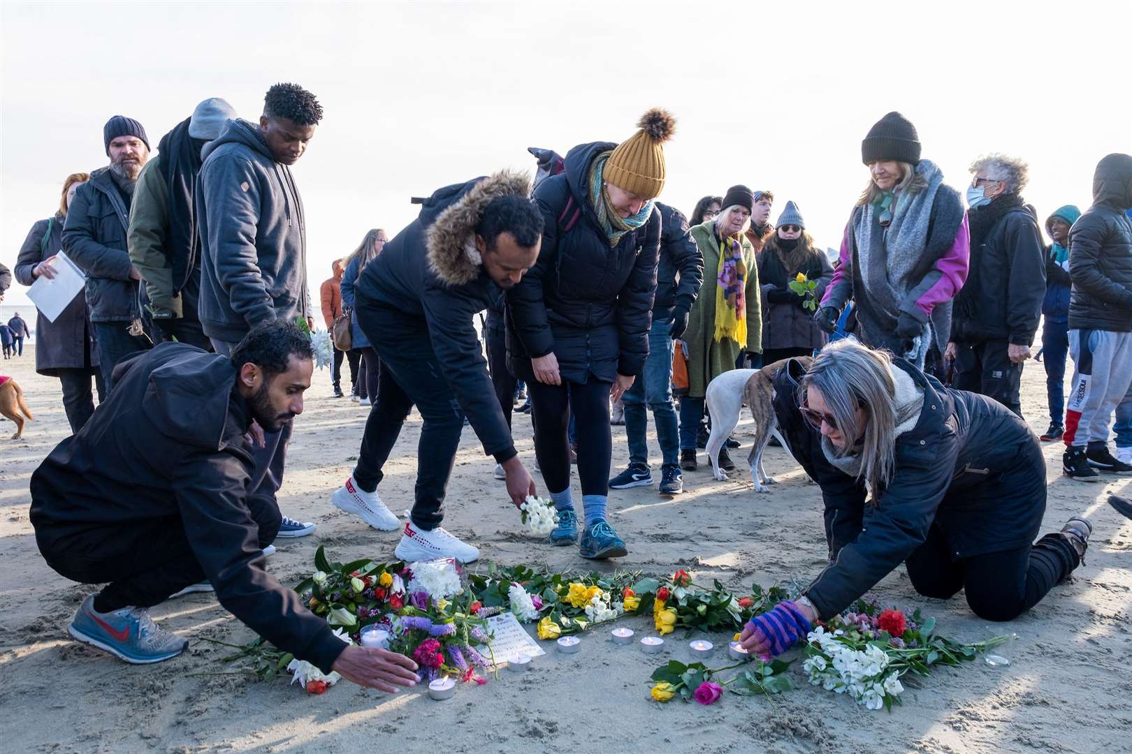 Local residents lay flowers on the sand on Sunny Sands Beach in response to the people who were tragically killed while crossing the channel. Picture: Andy Aitchison