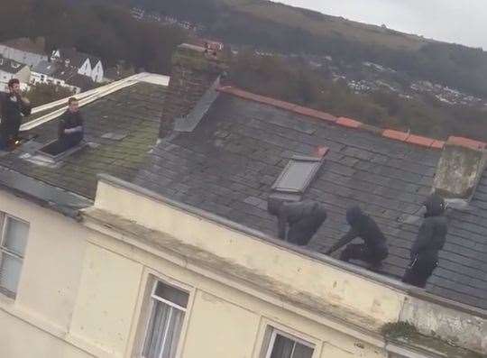 Police confronting the burglars on a rooftop in Guildhall Street, Folkestone, on October 20 last year