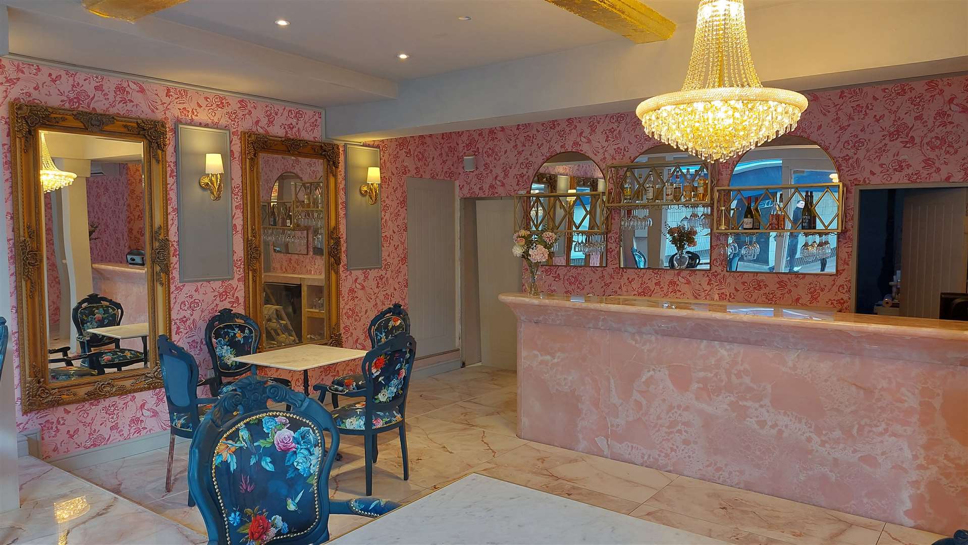 There is a pink bar and custom-made furniture